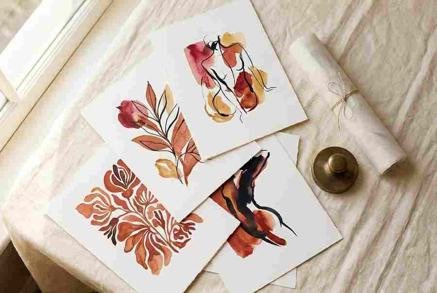 A flat-lay of fine art prints on linen